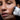 Photo of a woman using a facial lift device.