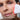Photo of a woman using NuFace wrinkle reducer facial device.