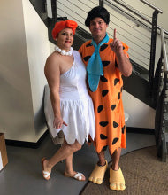 a photograph of two happy NuFACE employees dressed as Fred and Wilma Flintstone